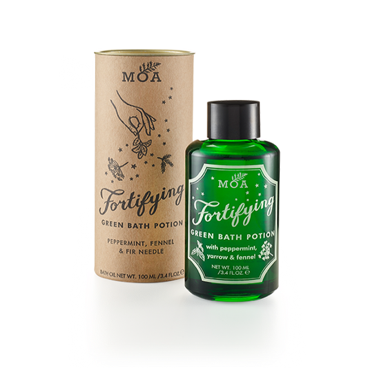 Green bottle of Magic Organic Apothecary Fortifying Green Bath Potion with peppermint, yarrow and fennel with black lid and natural cardboard tube packaging